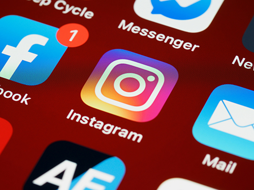 Private investigator reviewing social media profiles to gather evidence for an ongoing investigation.